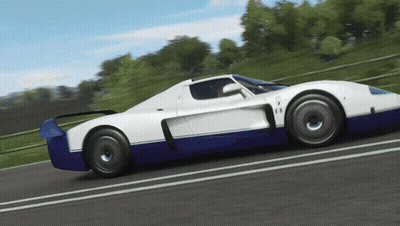 A Blue And White Sports Car Is Driving Down The Road GIF