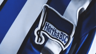 A Blue And White Striped Shirt With A Patch That Says Hertha Bsc On It GIF