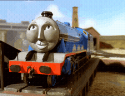 A Blue And White Train With A Face On The Front Of It GIF