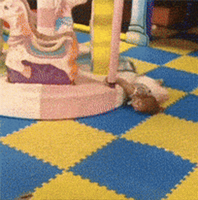 A Blue And Yellow Checkered Floor With A Carousel On It GIF