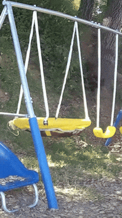 A Blue And Yellow Swing Set With A Yellow Swing In The Middle GIF