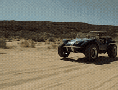 A Blue Buggy Is Driving Through A Sandy Desert GIF