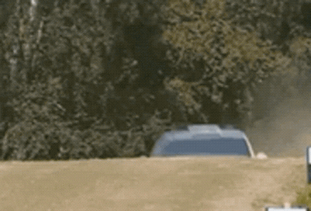 A Blue Car Is Driving Down A Dirt Road GIF