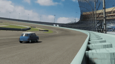 A Blue Car Is Driving Down A Race Track With A Fence Around It GIF