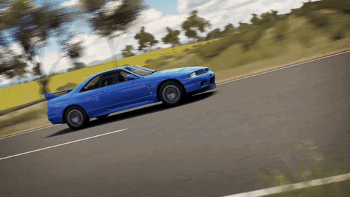 A Blue Car Is Driving Down A Road In A Video Game GIF