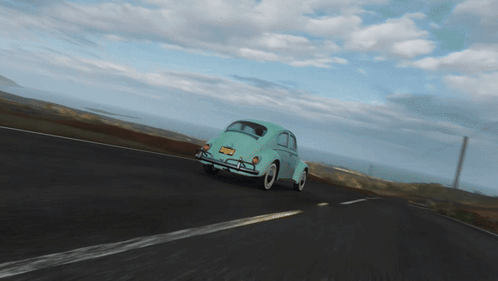 A Blue Car Is Driving Down The Road With A Windmill In The Background GIF