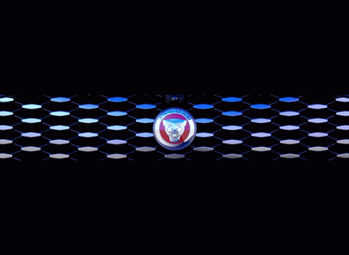 A Blue Car With A Jaguar Emblem On The Front GIF