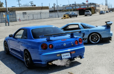 A Blue Car With A License Plate That Says ' Nism ' On It GIF