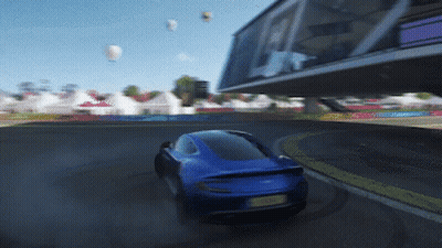 A Blue Car With A Yellow License Plate Is Driving Down A Track GIF