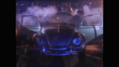 A Blue Car With The Doors Open Is Surrounded By Smoke GIF