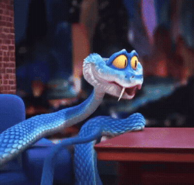 A Blue Cartoon Snake With Yellow Eyes Is Sitting On A Table GIF