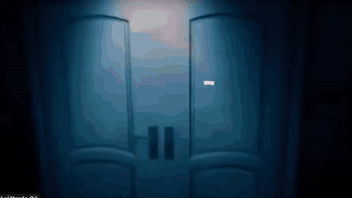 A Blue Door With A Light Shining Through It GIF