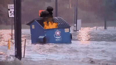 A Blue Dumpster With The Word Rescue On It Is In The Water GIF