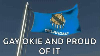 A Blue Flag With Oklahoma Written On It Is Flying In The Wind GIF