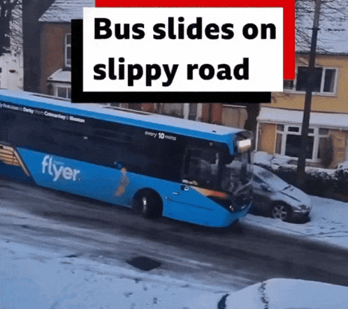 A Blue Flyer Bus Is Driving On A Snowy Road GIF