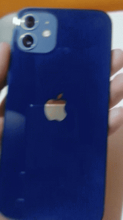 A Blue Iphone Is Being Held In A Person 'S Hand . GIF
