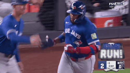 A Blue Jays Baseball Player Is Running On The Field During A Game GIF