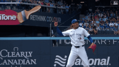 A Blue Jays Pitcher Throws A Pitch In Front Of An Ad For Rethink Colour GIF