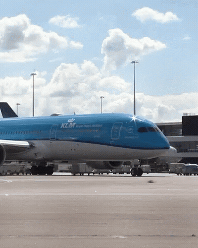 A Blue Klm Airplane Sits On The Tarmac At An Airport GIF