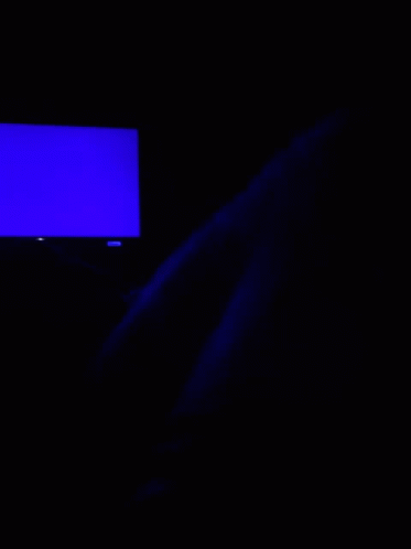 A Blue Light Is Shining On A Dark Surface In The Dark . GIF