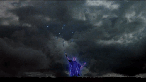 A Blue Lightning Bolt Strikes A Person In The Dark GIF