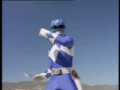 A Blue Power Ranger Is Standing In Front Of A Blue Sky Holding A Sword . GIF