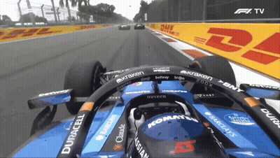 A Blue Race Car Is Driving Down A Track With Dhl And Dhl Signs In The Background GIF