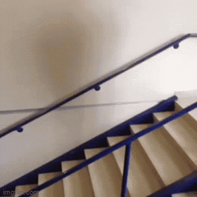 A Blue Railing On A Set Of Stairs With A White Wall GIF
