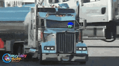 A Blue Semi Truck With Monkey Baby Graphics Written On The Bottom GIF