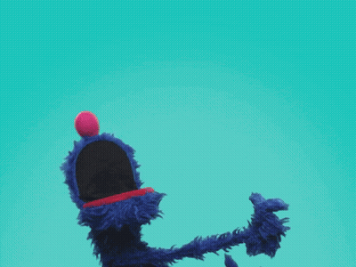 A Blue Sesame Street Character Giving A Thumbs Up With His Mouth Open GIF