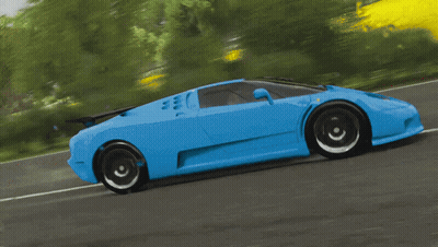 A Blue Sports Car Is Driving Down A Road Next To A Yellow Wall GIF