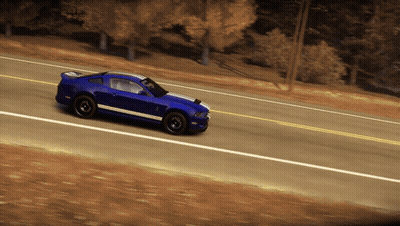 A Blue Sports Car Is Driving Down A Road With Trees In The Background GIF