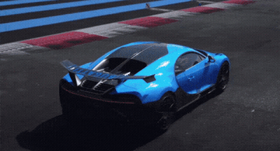 A Blue Sports Car Is Driving Down A Track With A Wing On The Back GIF