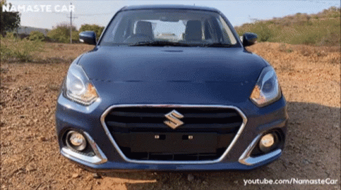 A Blue Suzuki Car Is Parked On A Dirt Field GIF