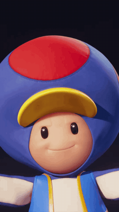 A Blue Toad With A Red Yellow And Blue Hat GIF
