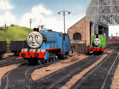 A Blue Train With The Number 1 On It Is On The Tracks GIF