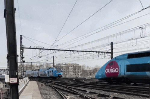 A Blue Train With The Word Ouigo On It GIF