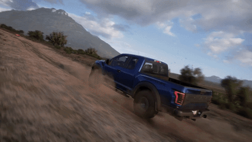 A Blue Truck Is Driving Down A Dirt Hill GIF