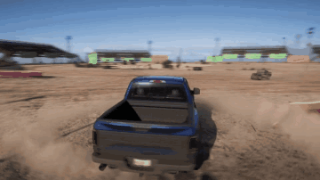 A Blue Truck Is Driving Through A Dirt Field With A California License Plate GIF
