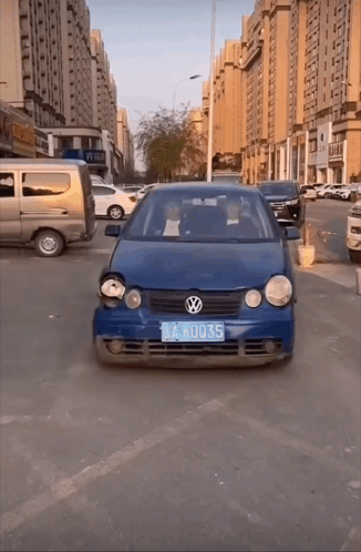 A Blue Volkswagen Car With A License Plate That Says Lkru035 GIF