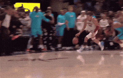 A Blurred Image Of A Basketball Game With A Crowd In The Stands GIF