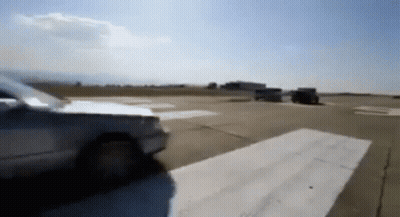 A Blurred Image Of A Car Driving Down A Runway GIF