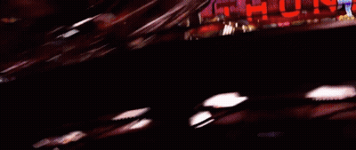 A Blurred Image Of A Car Driving Past A Sign That Says ' Urd ' GIF