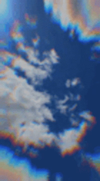 A Blurred Image Of A Cloudy Sky With A Rainbow In The Middle . GIF