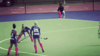 A Blurred Image Of A Field Hockey Game With A Player Wearing A Number 2 Jersey GIF