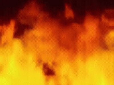 A Blurred Image Of A Fire Burning In The Dark GIF
