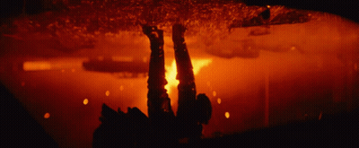A Blurred Image Of A Fire In A Dark Room With A Red Background GIF