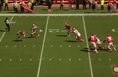 A Blurred Image Of A Football Game With A Player Wearing A Red Jersey That Says ' Washington ' On It GIF