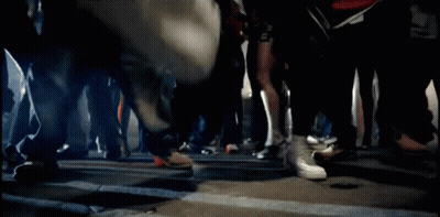 A Blurred Image Of A Group Of People Walking Down A Street GIF