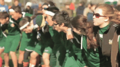 A Blurred Image Of A Group Of People Wearing Green Shirts With The Number 7 On The Front GIF